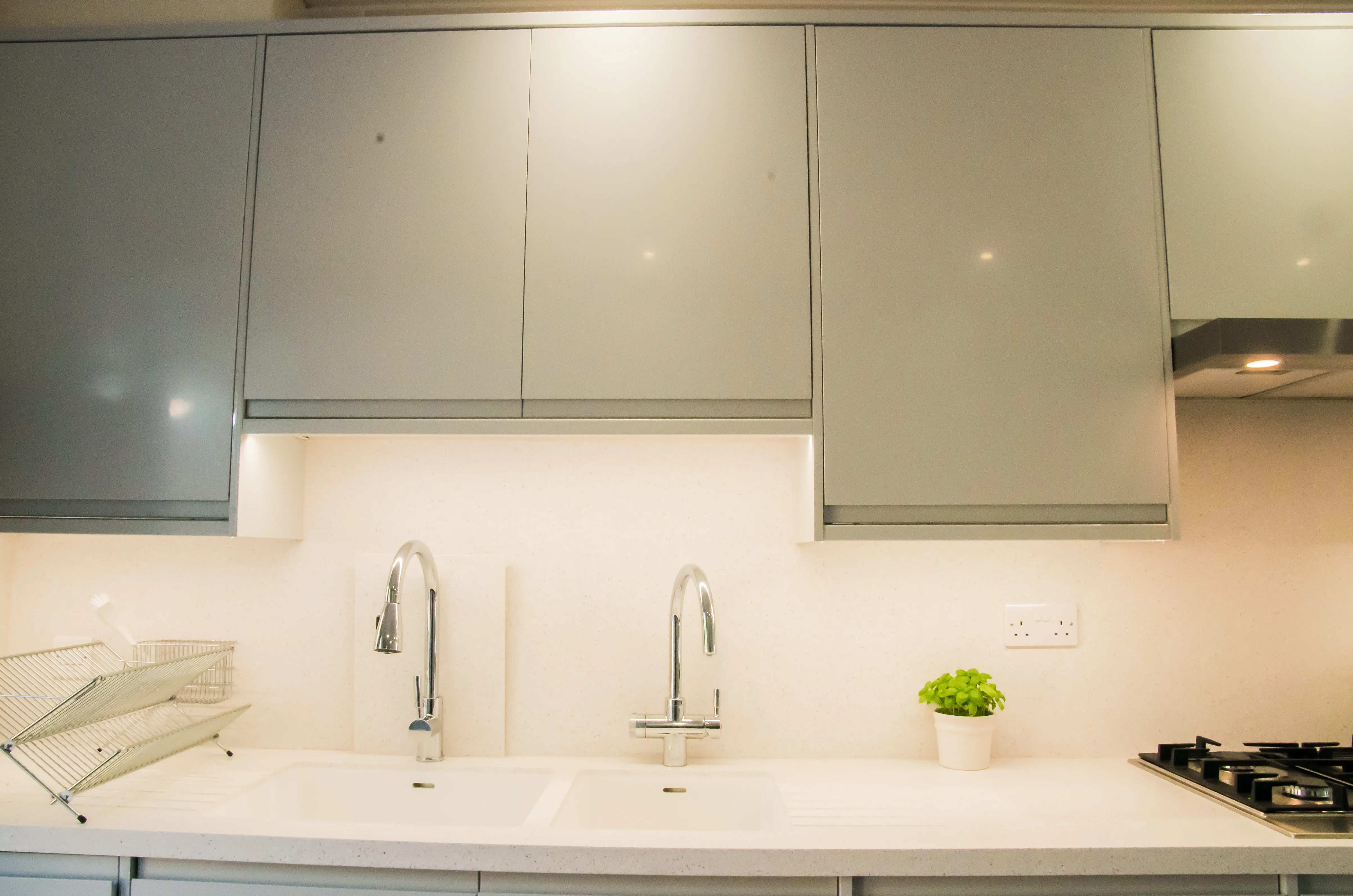 A kitchen with a sink and a stove top oven.