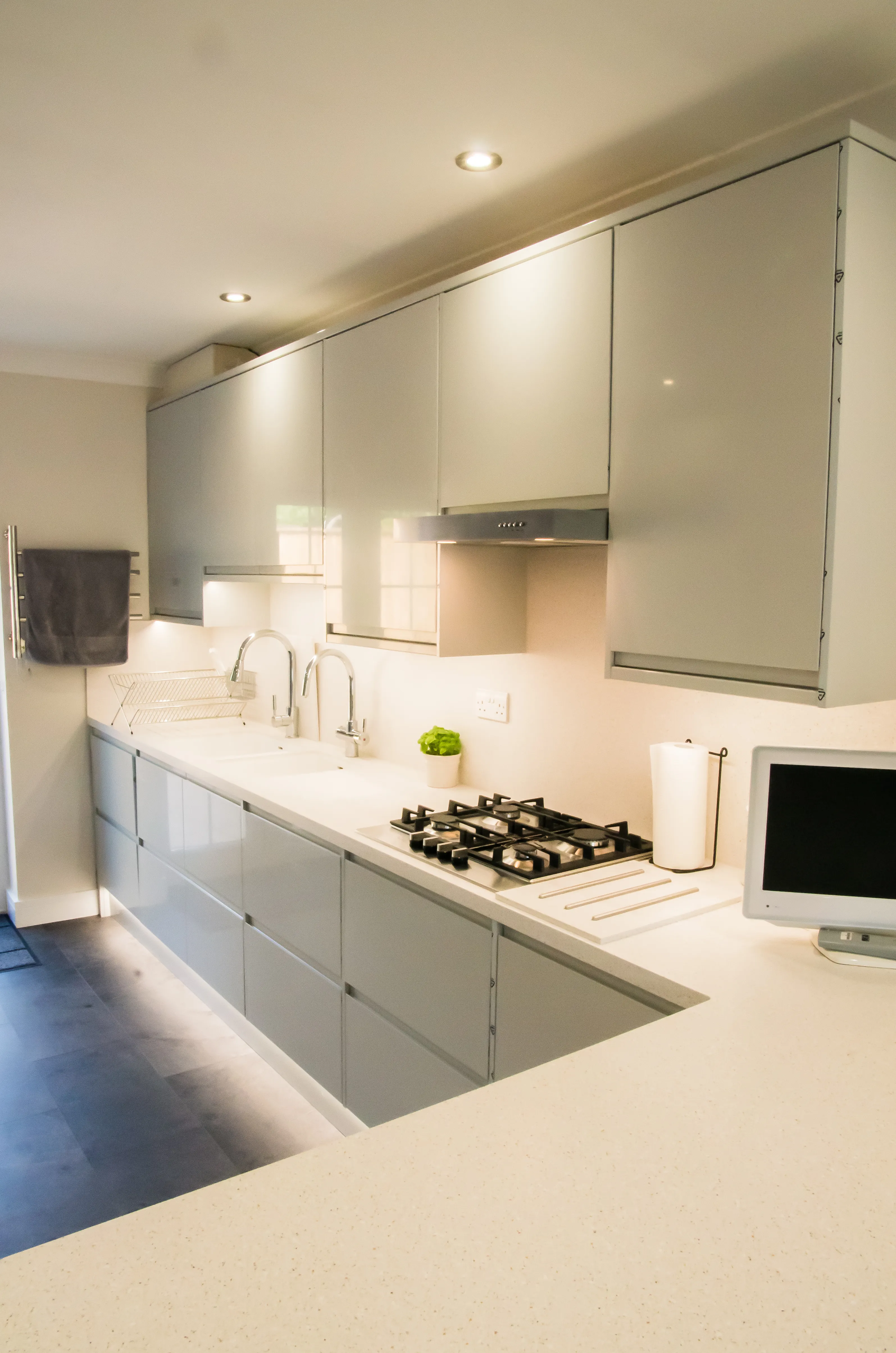 A kitchen with a stove top oven sitting next to a microwave.