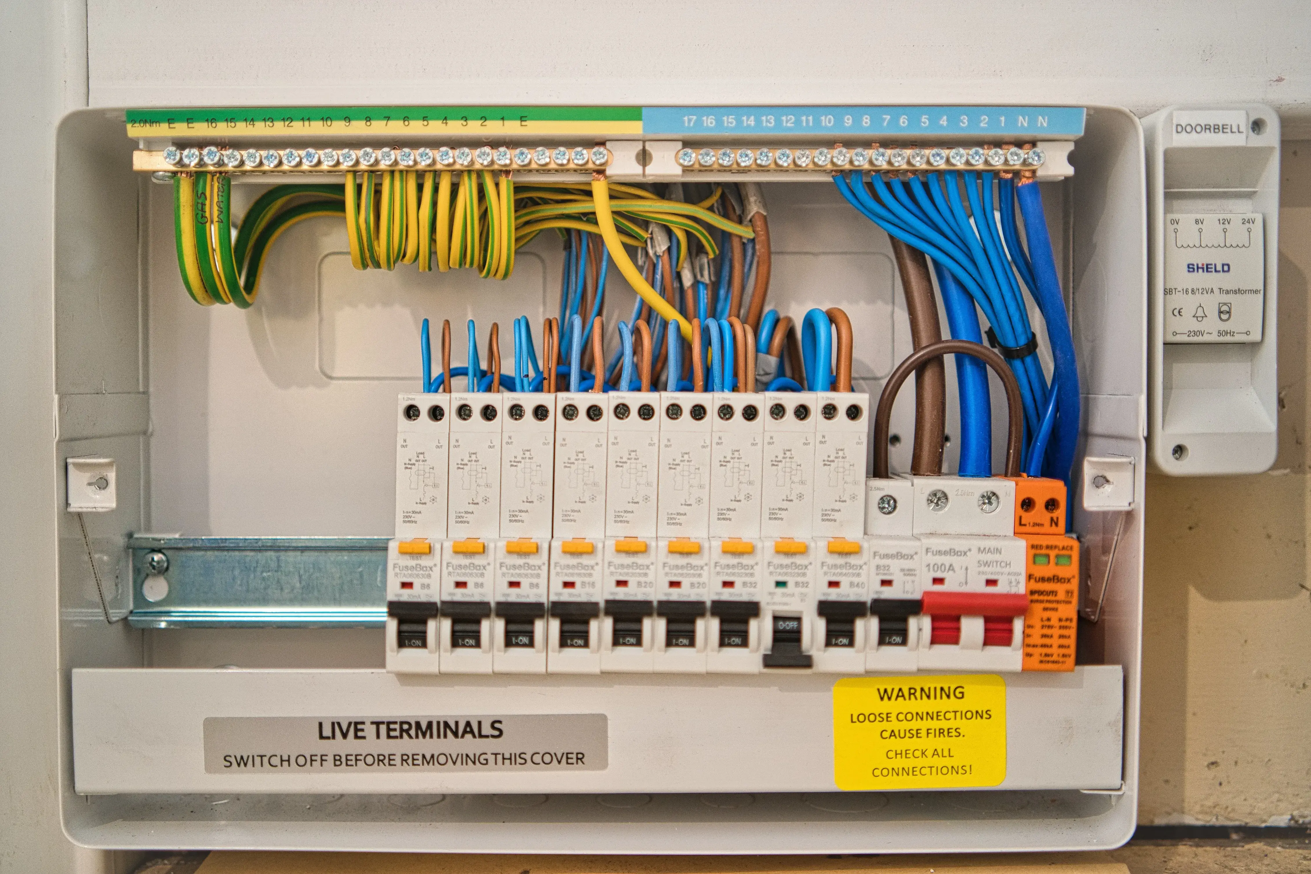An electrical panel with multiple wires and wires in it.