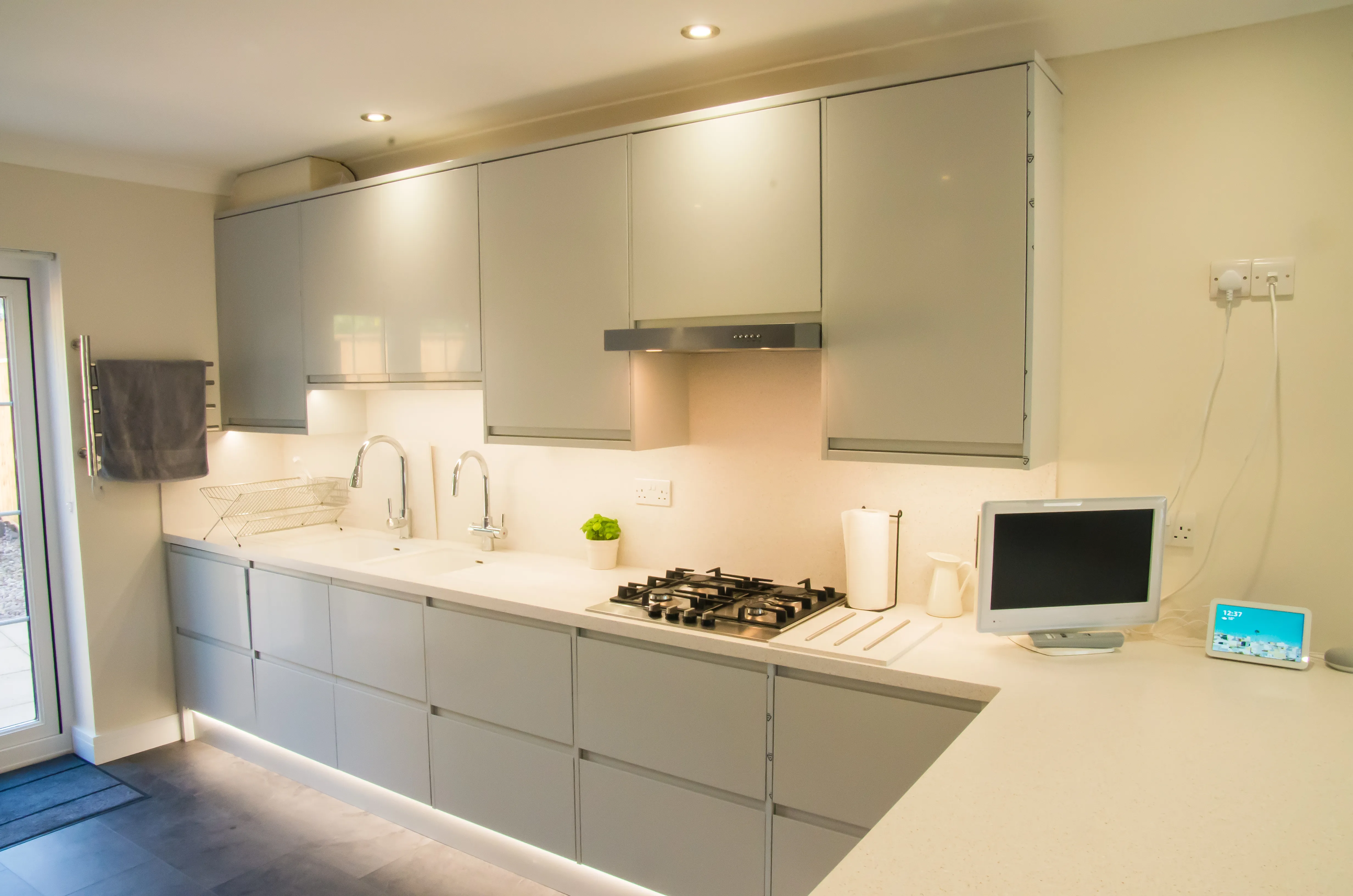 A kitchen with a computer on the counter.