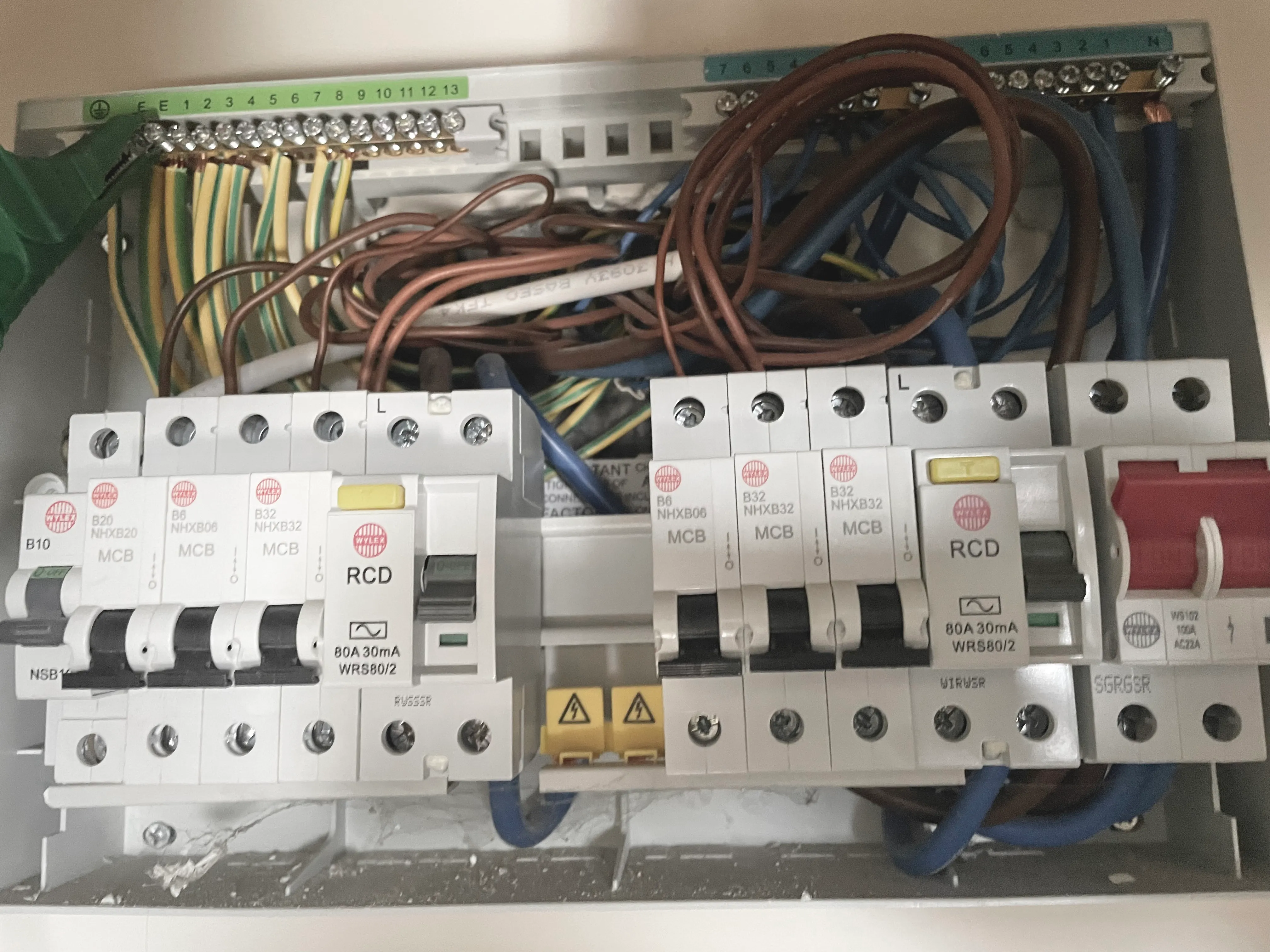 A close up of a circuit box with multiple wires.